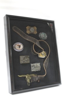 Wall Dec, Collection, CLEARED, LOOPED STUDDED LEATHER BELT W/COLLECTION OF VINTAGE & ANTIQUE BELT BUCKLES INCLUDING STEER HEAD, BASS FISH, WESTERN, AMERICANA, BLACK / BROWN SHADOW BOX FRAME W/BLACK BACKING, METAL, BLACK