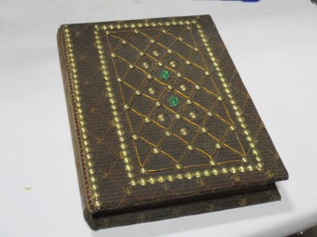 Book, Medieval, Greeny Brown Diamond Patterned Upholstry Cover. Brown Leather Spine. Studs On Cover. Two Green Gems. Lace Trim., BROWN