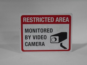 Sign, Prohibit, RESTRICTED AREA MONITORED BY VIDEO CAMERA, WHITE BACKGROUND, WHITE AND BLACK TEXT, METAL, WHITE