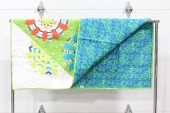 Bedding, Quilt, CLEARED, HANDMADE QUILT / WALL HANGING, FRONT IS MULTICOLOURED PATTERN ON WHITE, BACK IS BLUE PURPLE & GREEN PATTERN, FABRIC, MULTI-COLORED